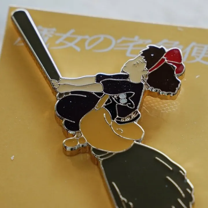 Pins Kiki on her broom - Kiki's Delivery Service
